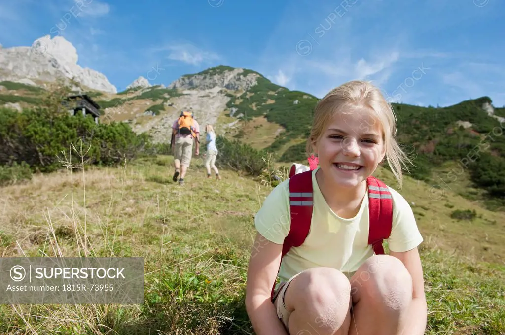 Austria, Salzburg Country, Filzmoos, Girl smiling with parents in background