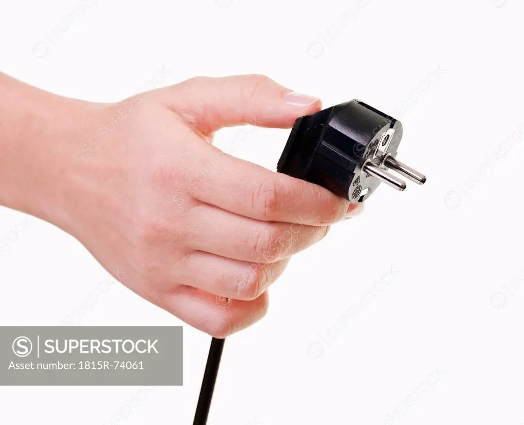 Human hand holding power cord, close_up