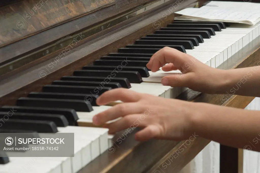 Germany, Bavaria, Girl using piano and making music