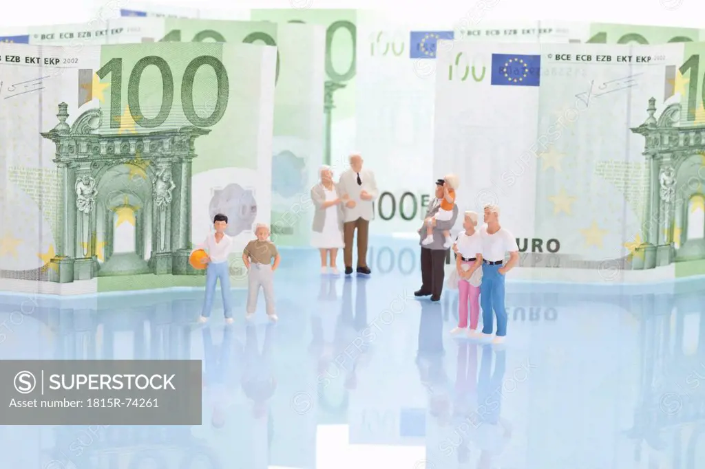 Figurines standing in front of 100 euro note