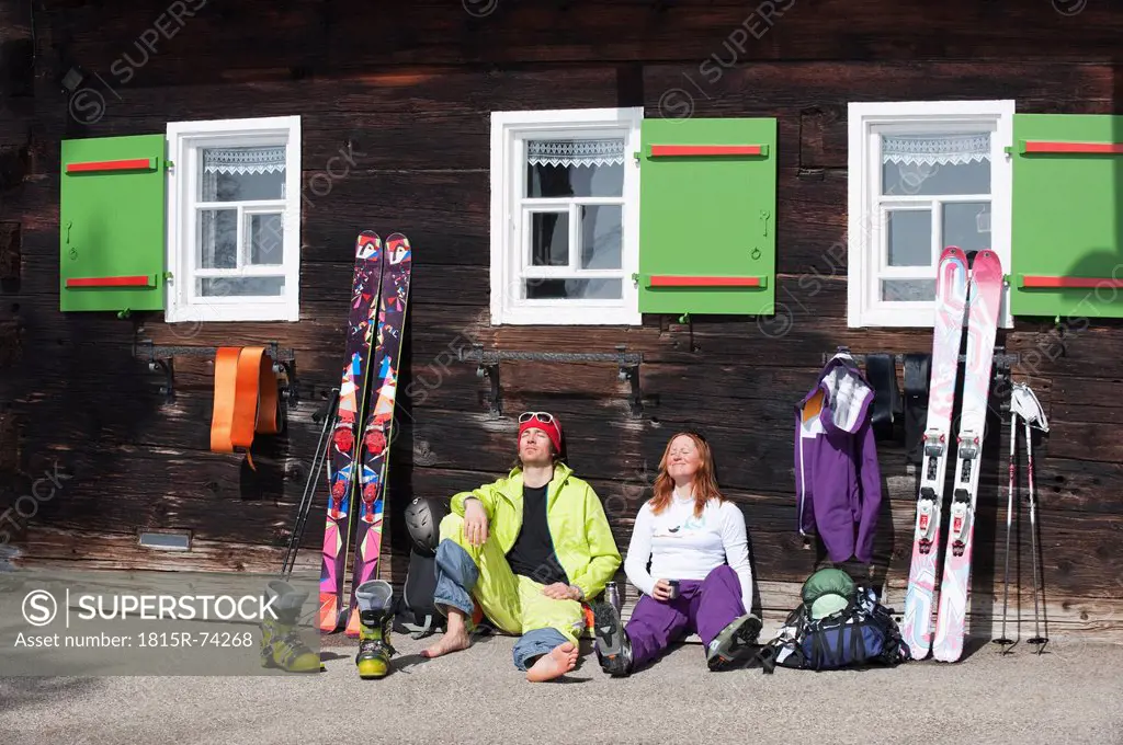 Austria, Kleinwalsertal, Couple relaxing outside mountain hut