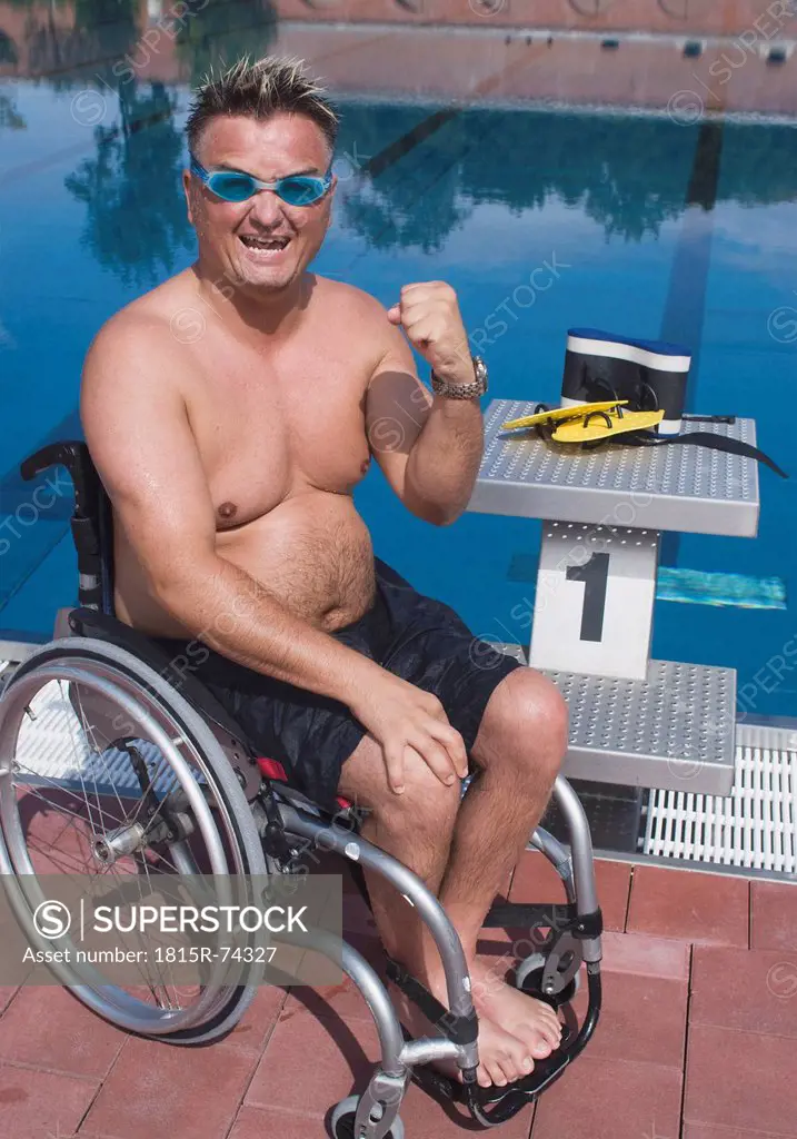 Germany, Ingolstadt, Disabled man on wheelchair by pool