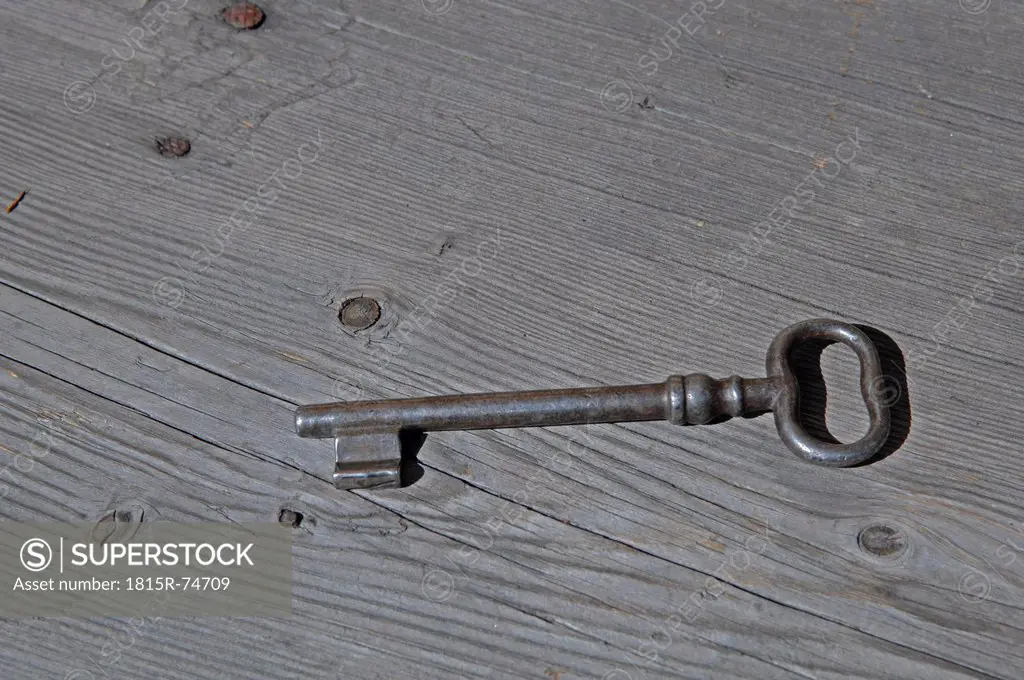 Germany, An old key on wooden Plank