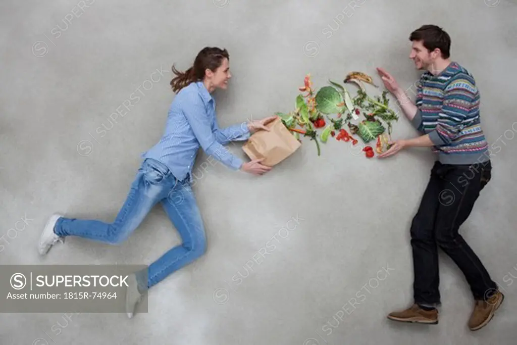 Man and woman balancing vegetables