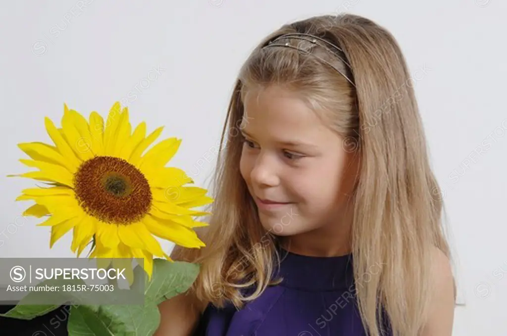 Girl 10_11 Years looking at sunflower
