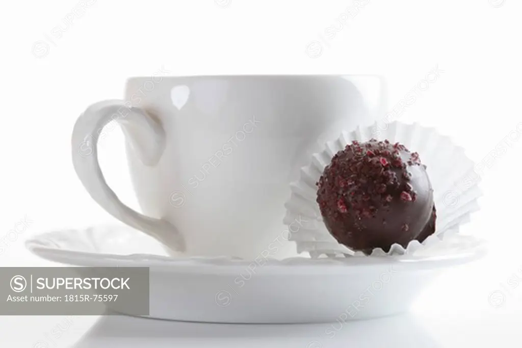 Coffee cup with chocolate on white background, close up