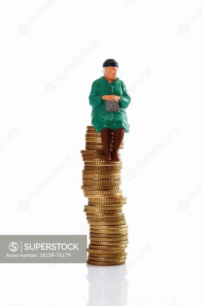 Figurine grandma sitting on coin stack