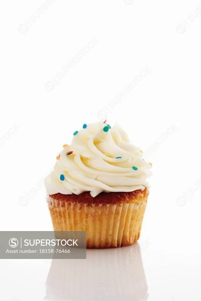 Close up of buttercream vanilla cupcake against white background