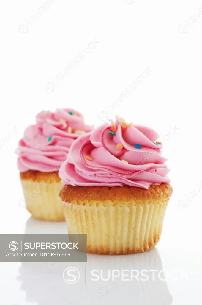 Close up of buttercream strawberry cupcake against white background