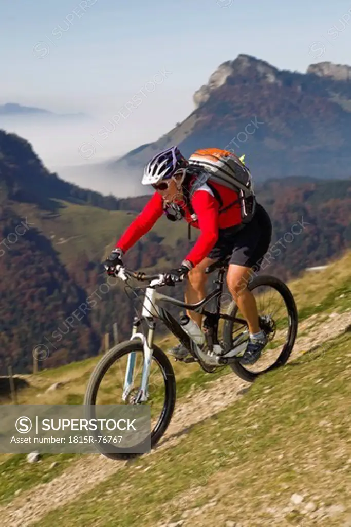 Austria, Tirol, Female mountain biker biking on spitzstein mountain