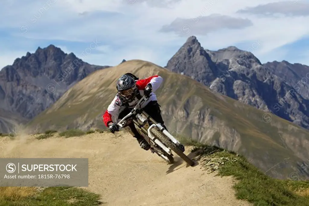Italy, Livigno, View of man free riding mountain bike downhill