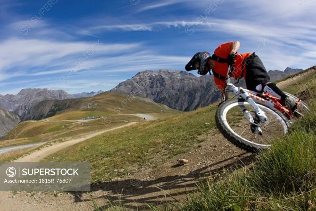 Italy, Livigno, View of man free riding mountain bike downhill