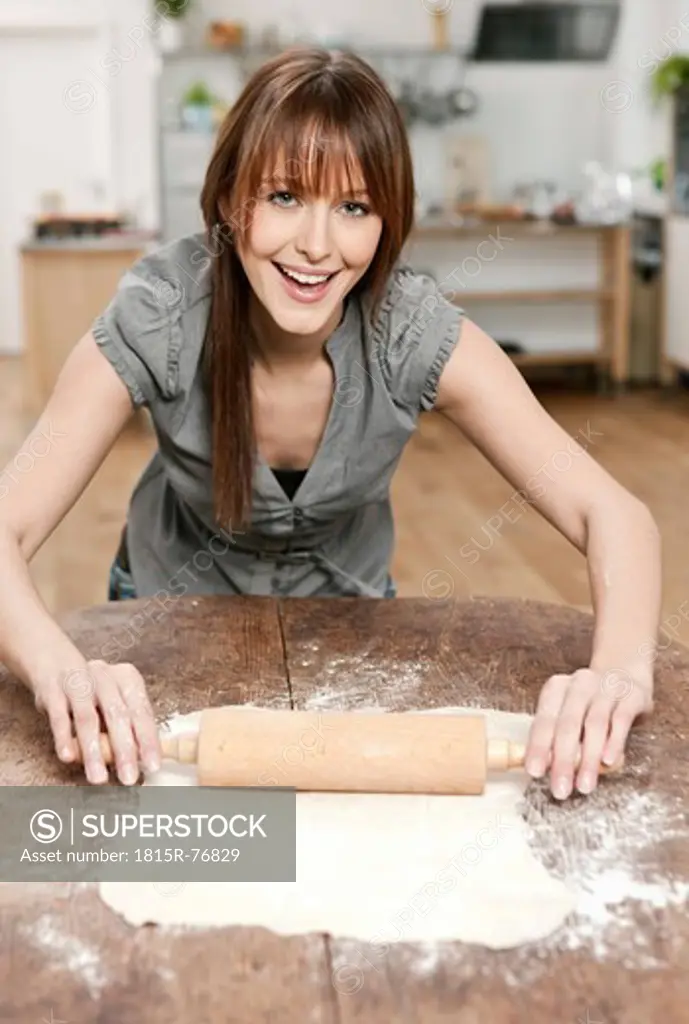 Germany, Cologne, Woman rolling dough