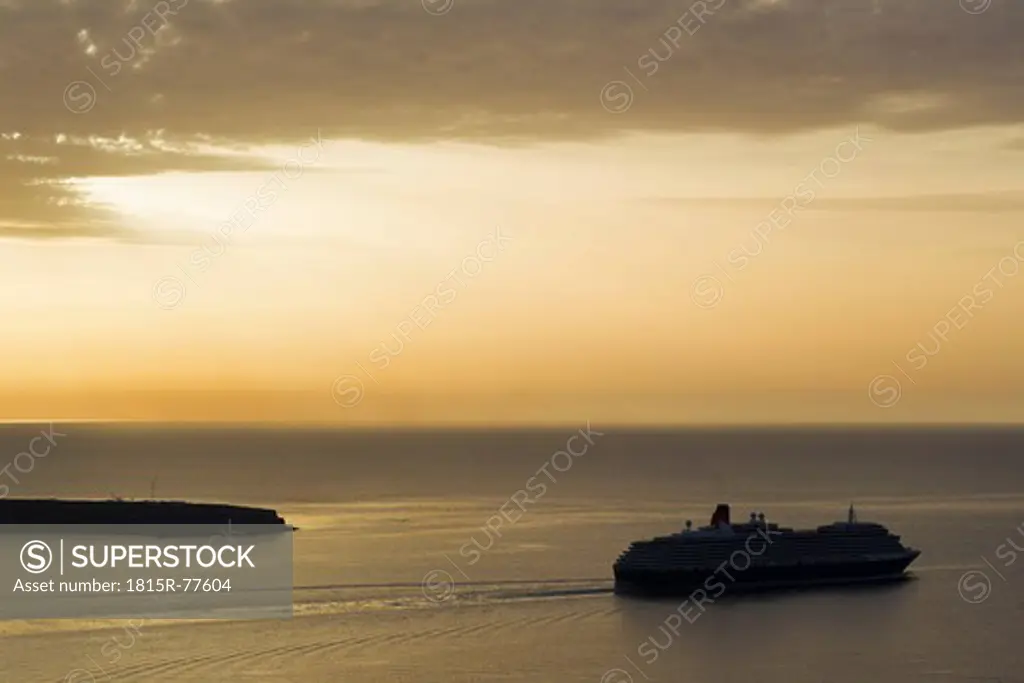 Europe, Greece, Thira, Cyclades, Santorini, View of cruise liner in aegean sea at sunset