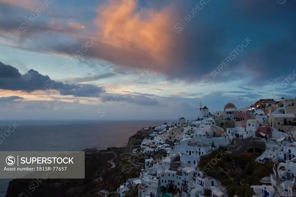 Greece, Cyclades, Thira, Santorini, View of Oia and windmills at sunset