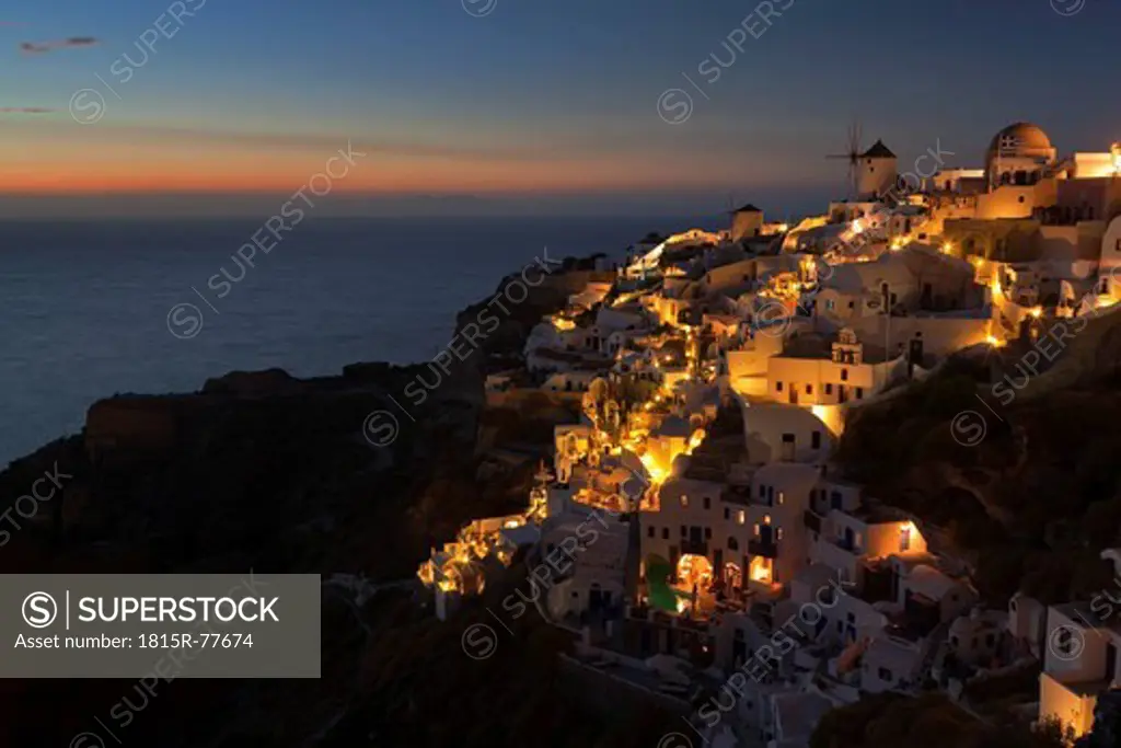 Greece, Cyclades, Thira, Santorini, View of Oia and windmills after sunset
