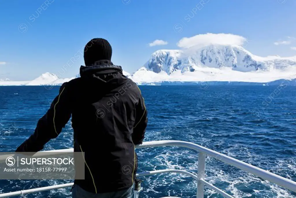 South Atlantic Ocean, Antarctica, Antarctic Peninsula, Gerlache Strait, Tourist standing on polar star icebreaker cruise ship