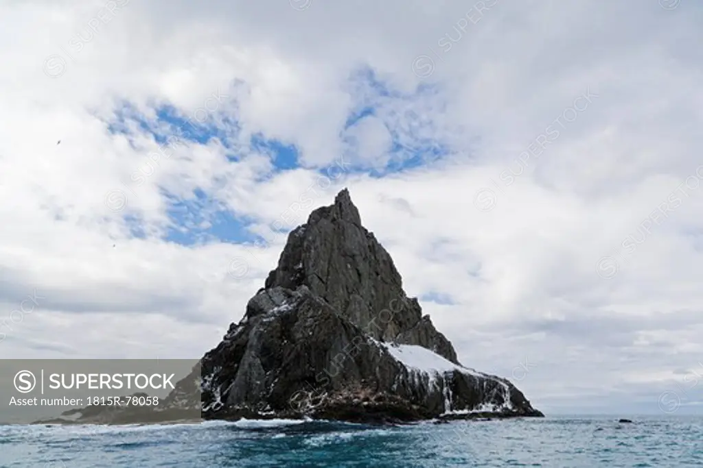 South Atlantic Ocean, Antarctica, South Shetland Islands, View of huge rock with Chinstrap Penguin near Elephant Island