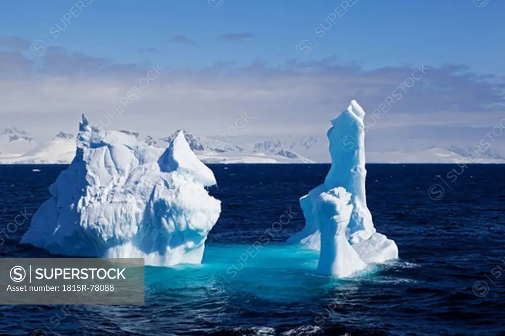 South Atlantic Ocean, Antarctica, Antarctic Peninsula, Gerlache Strait, View of iceberg with snow_covered mountain range in background