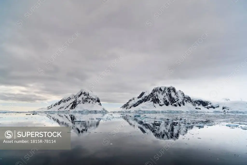 South Atlantic Ocean, Antarctica, Antarctic Peninsula, Lemaire Channel, View snow coverd mountain range and iceberg