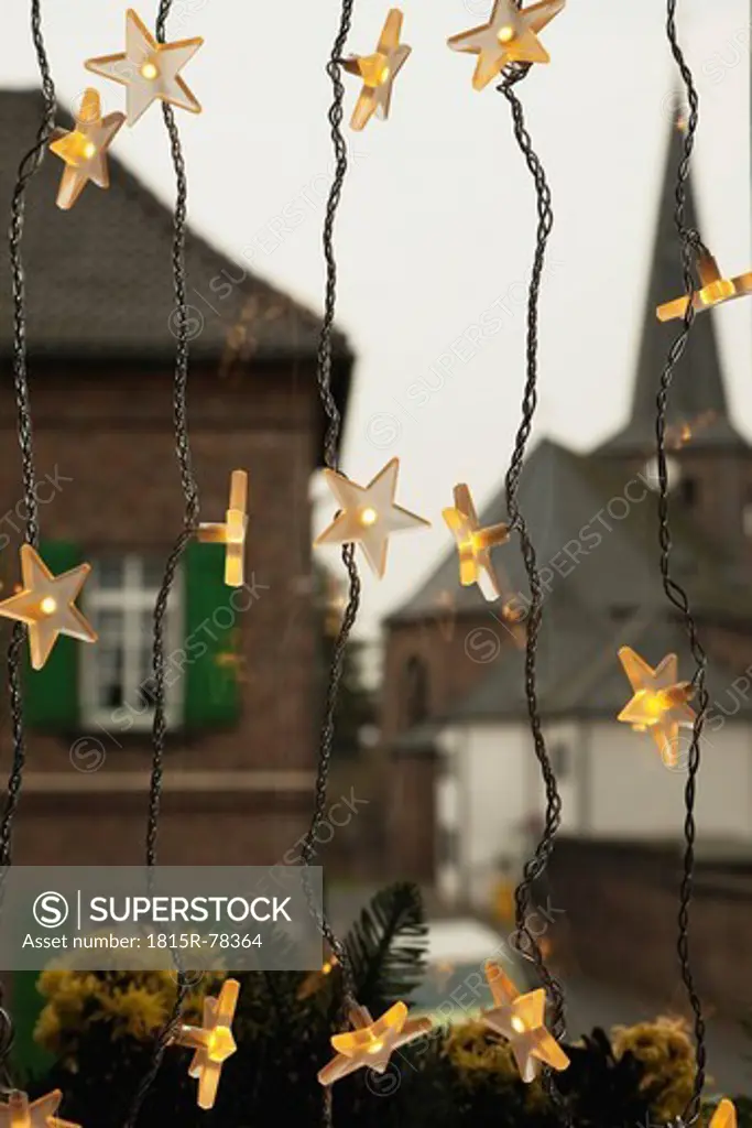 Germany, Cologne, Close up of illuminated stars as christmas window decoration