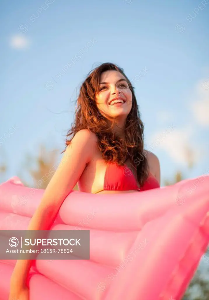 Croatia, Zadar, Young woman with air mattress on beach