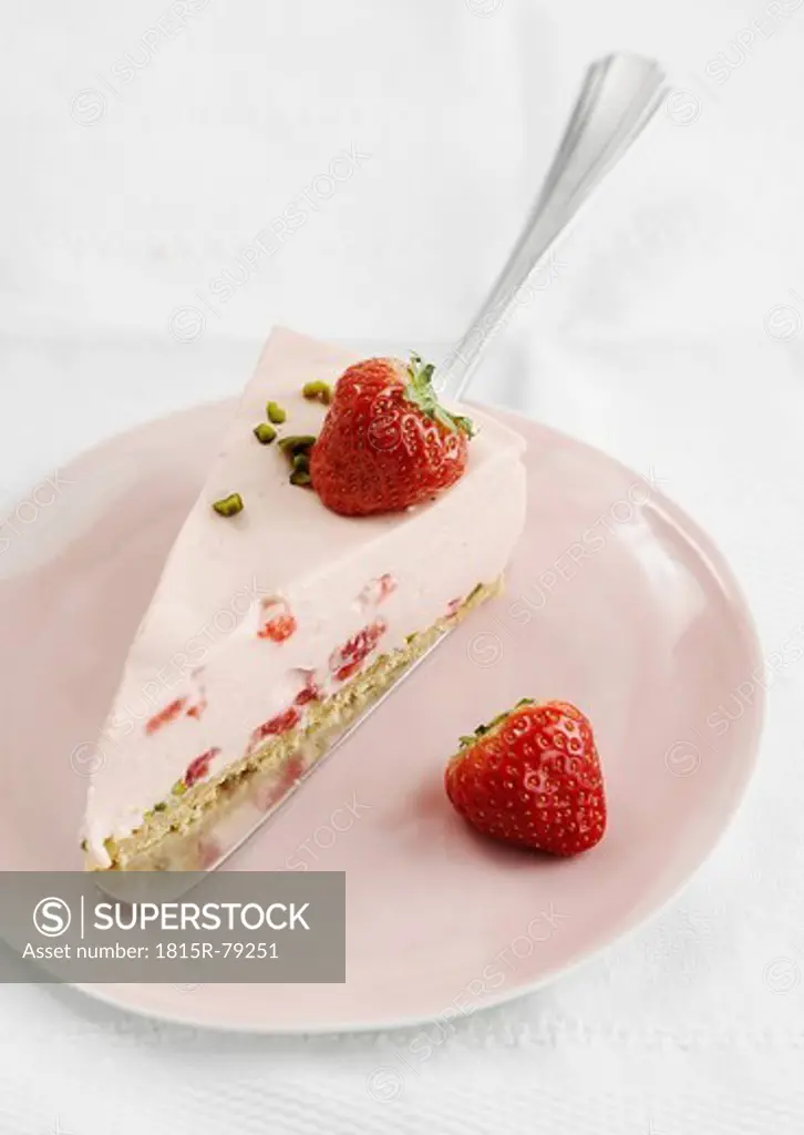 Cheesecake slice with strawberry in plate, close up