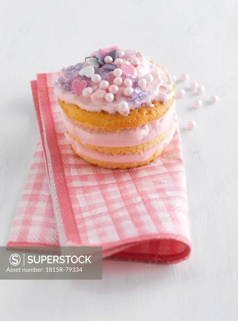 Close up of strawberry whoopie pie on napkin against white background