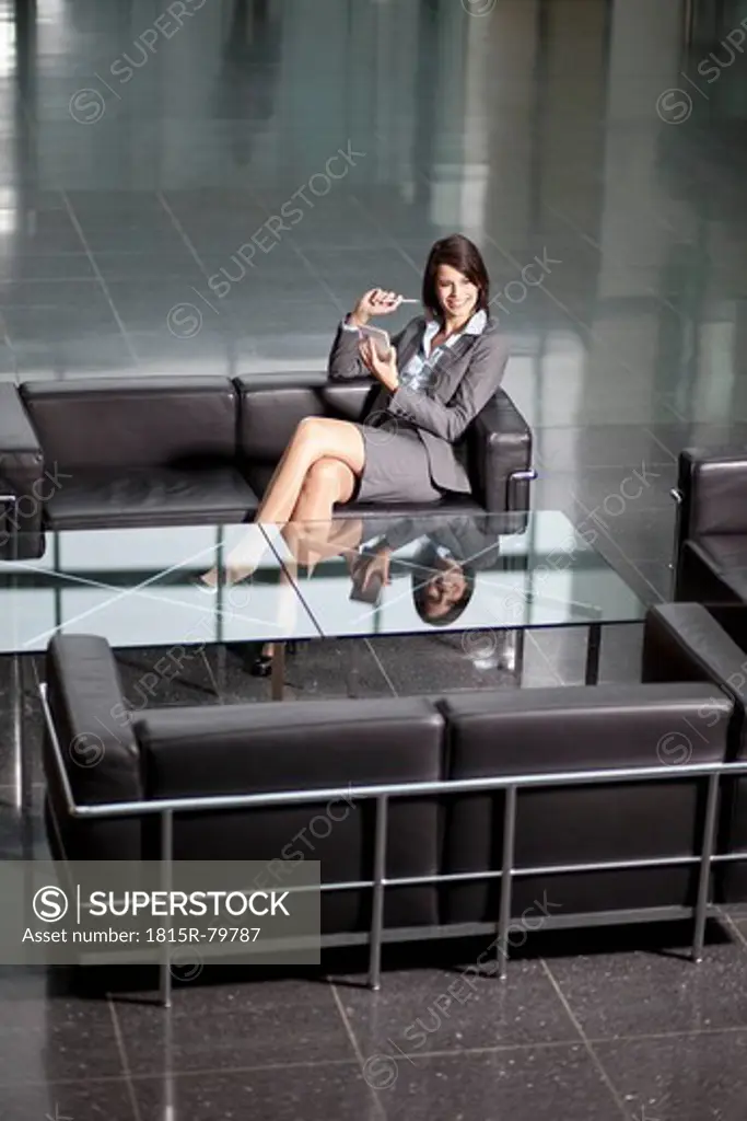 Germany, Bavaria, Business woman with PDAs