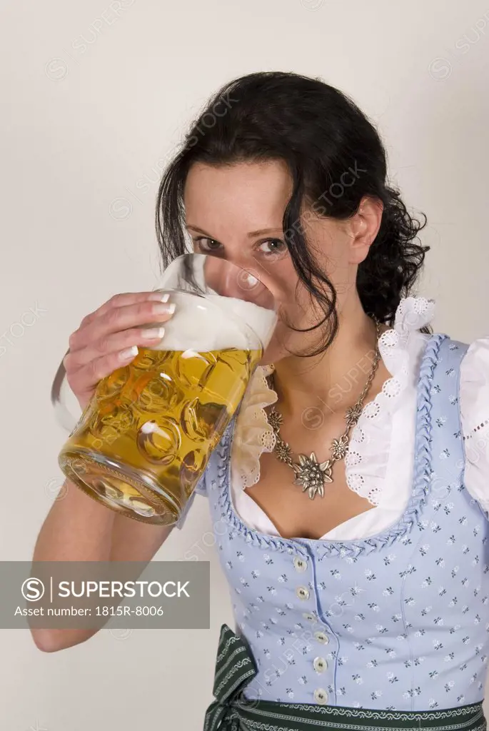 Young woman drinking beer, portrait