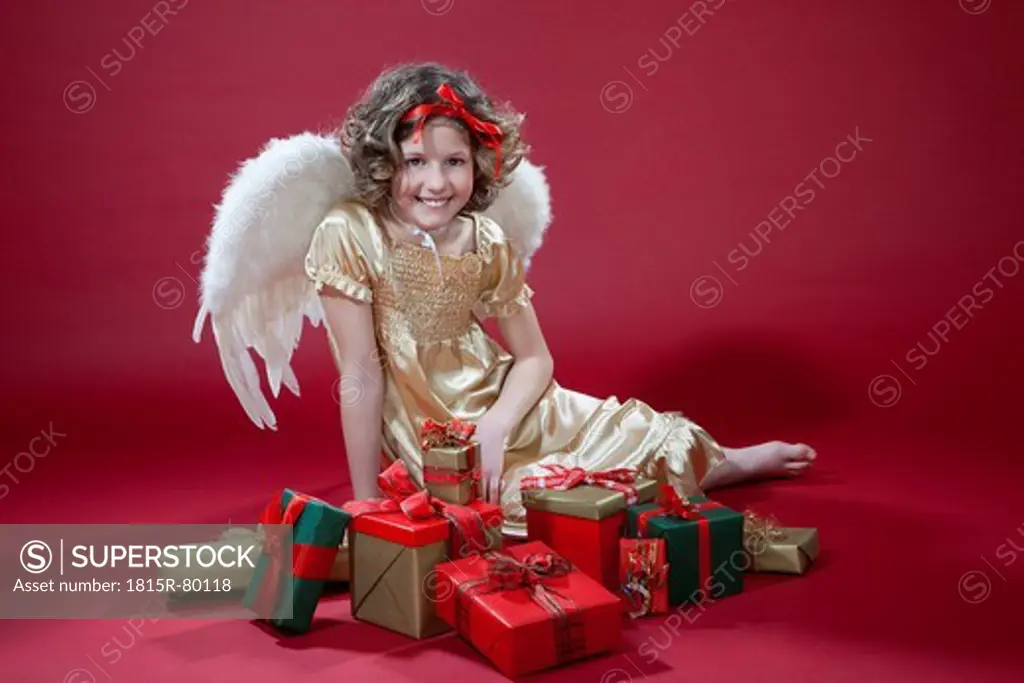 Girl sitting with gifts, smiling, portrait