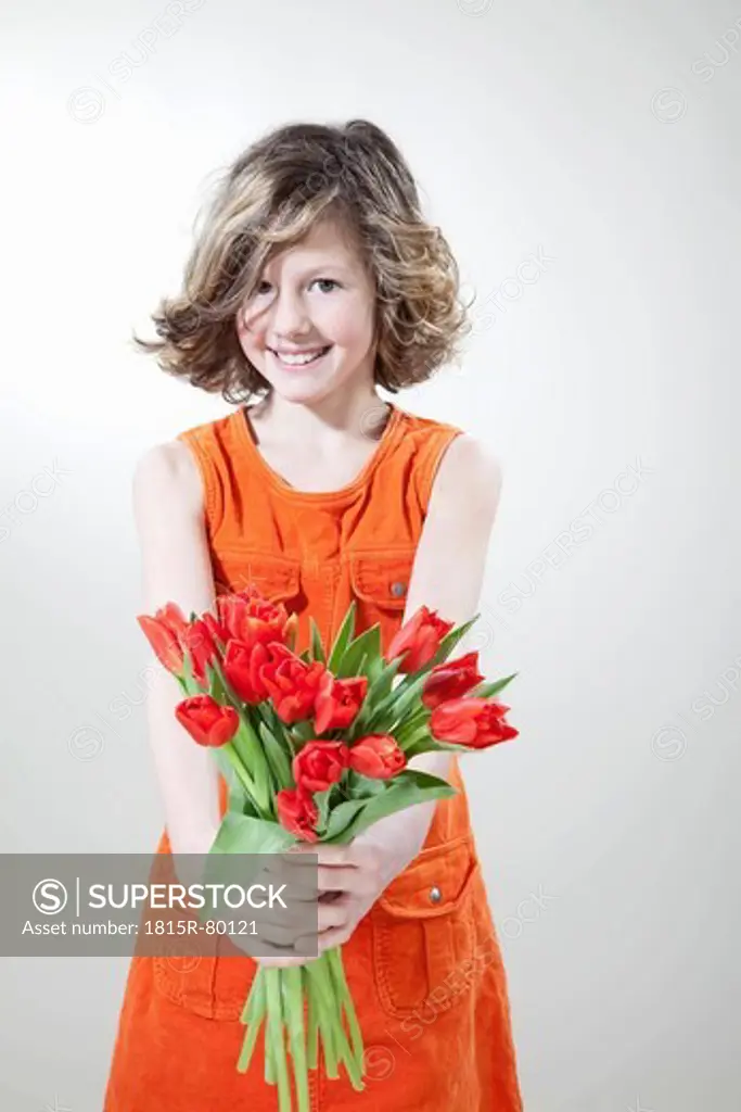 Girl with flowers for mother´s day, smiling, portrait