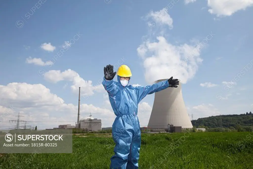Germany, Bavaria, Unterahrain, Man with protective workwear standing in field at AKW Isar