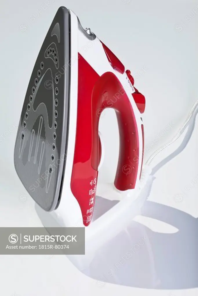 Close up of steam iron against white background