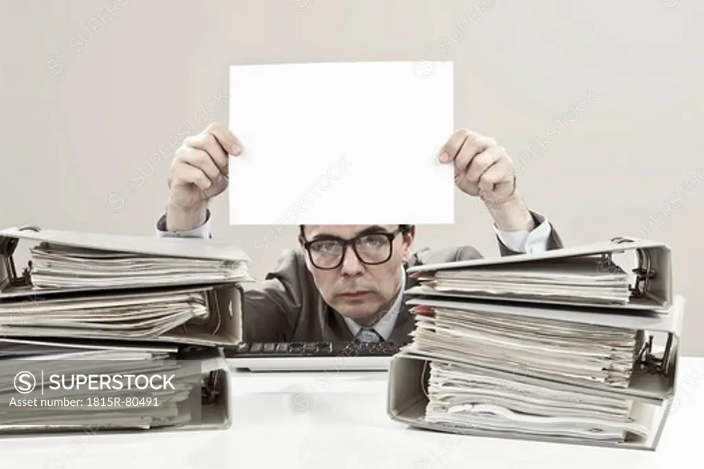 Close up of mature businessman holding blank paper