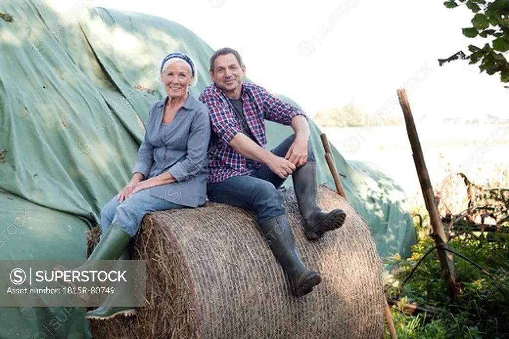 Germany, Saxony, Man and woman at the farm, smiling, portrait