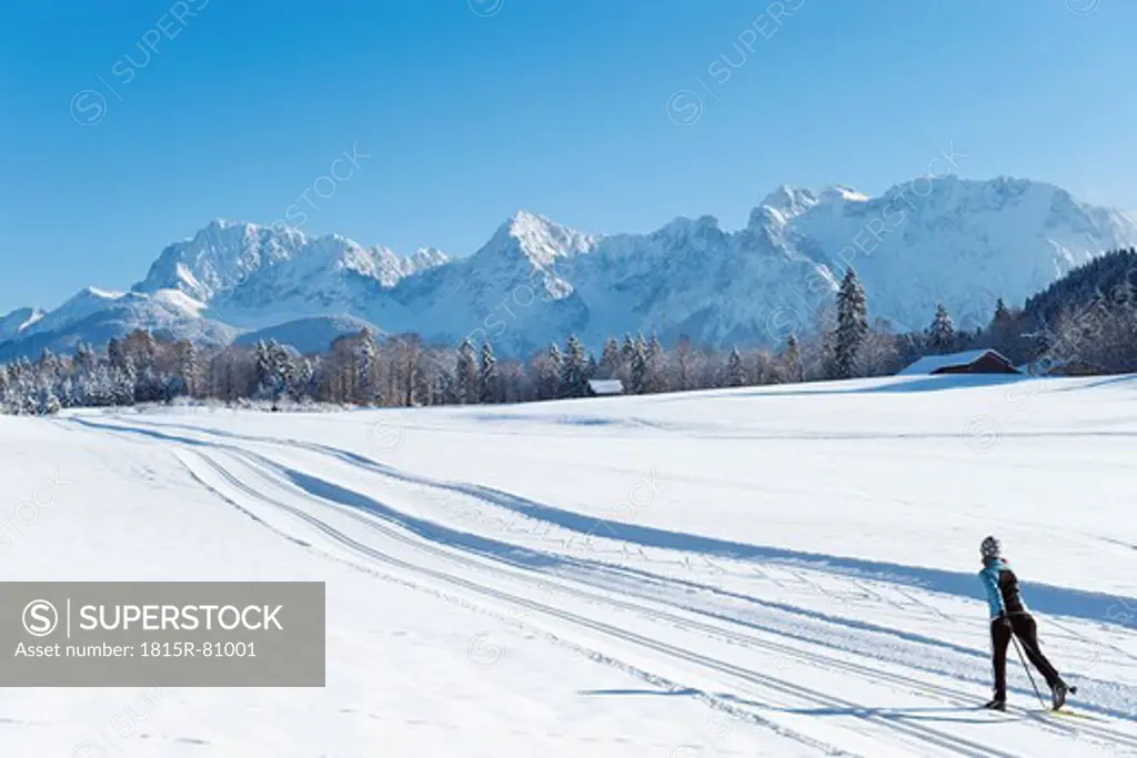 Germany, Bavaria, Isar Valley, Senior woman doing cross country skiing