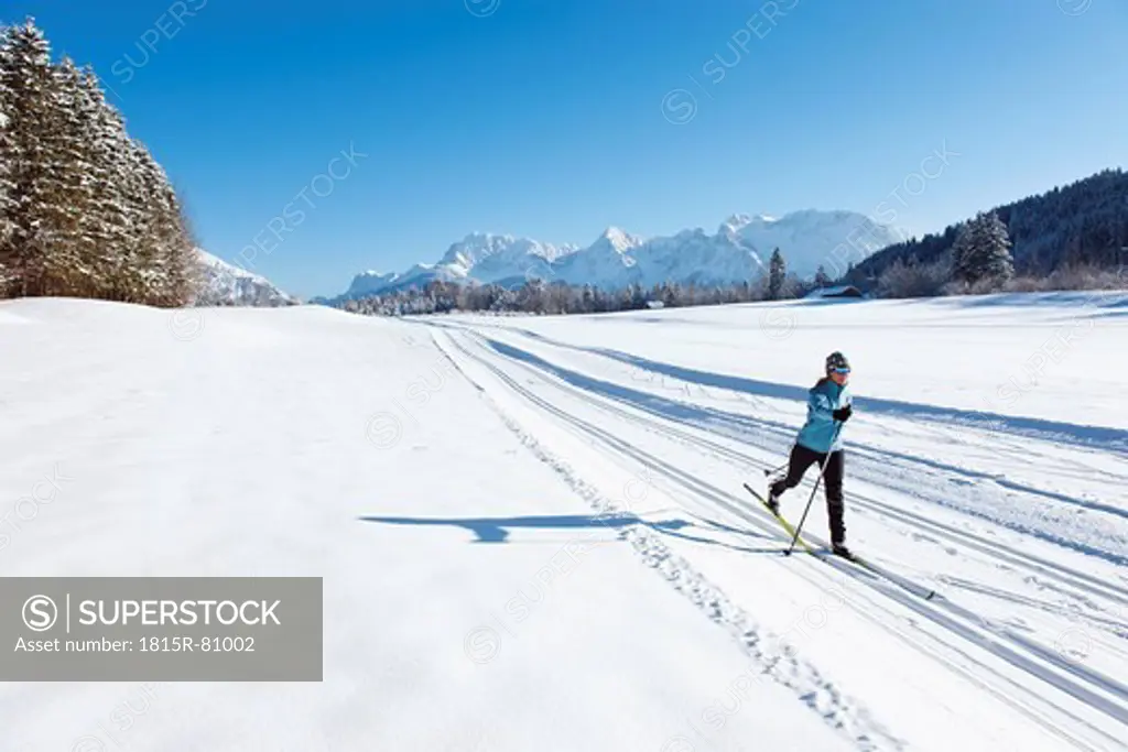 Germany, Bavaria, Isar Valley, Senior woman doing cross country skiing