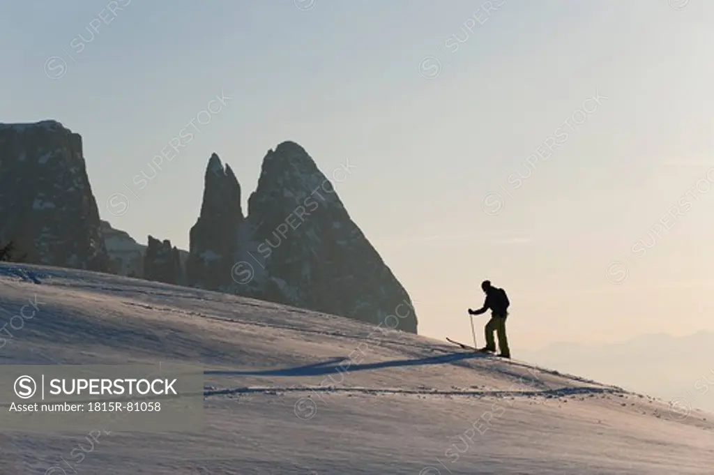 Italy, Trentino_Alto Adige, Alto Adige, Bolzano, Seiser Alm, Mid adult man on ski tour in morning