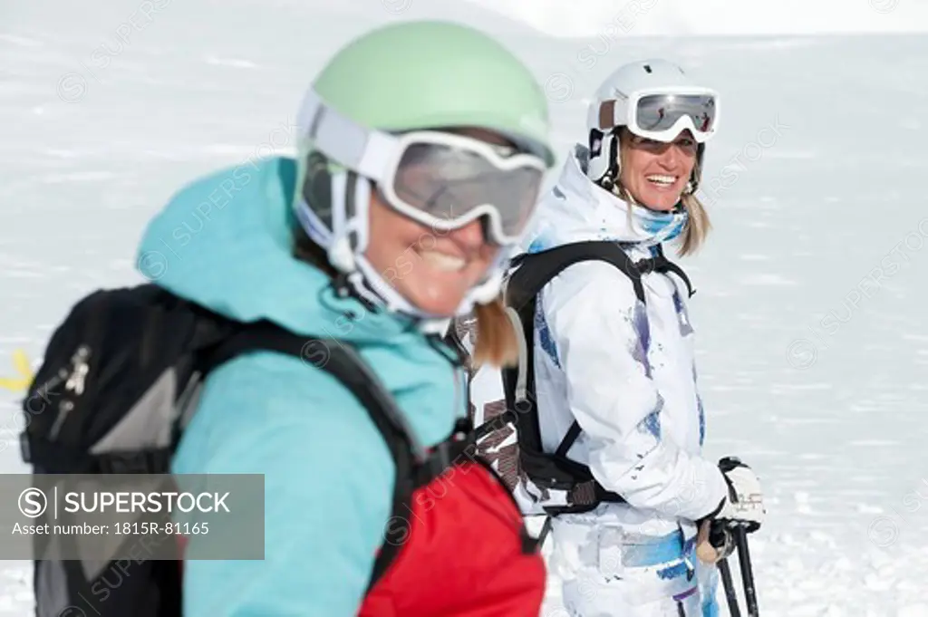 Austria, Kleinwalsertal, Women wearing ski goggles, smiling