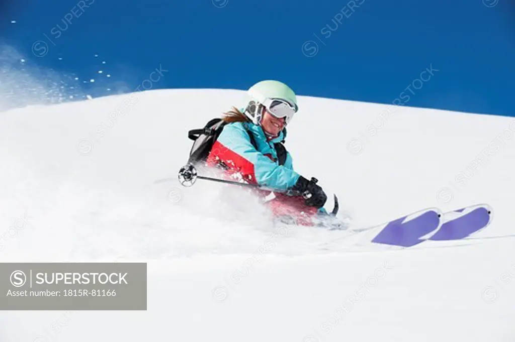 Austria, Kleinwalsertal, Woman skiing and smiling