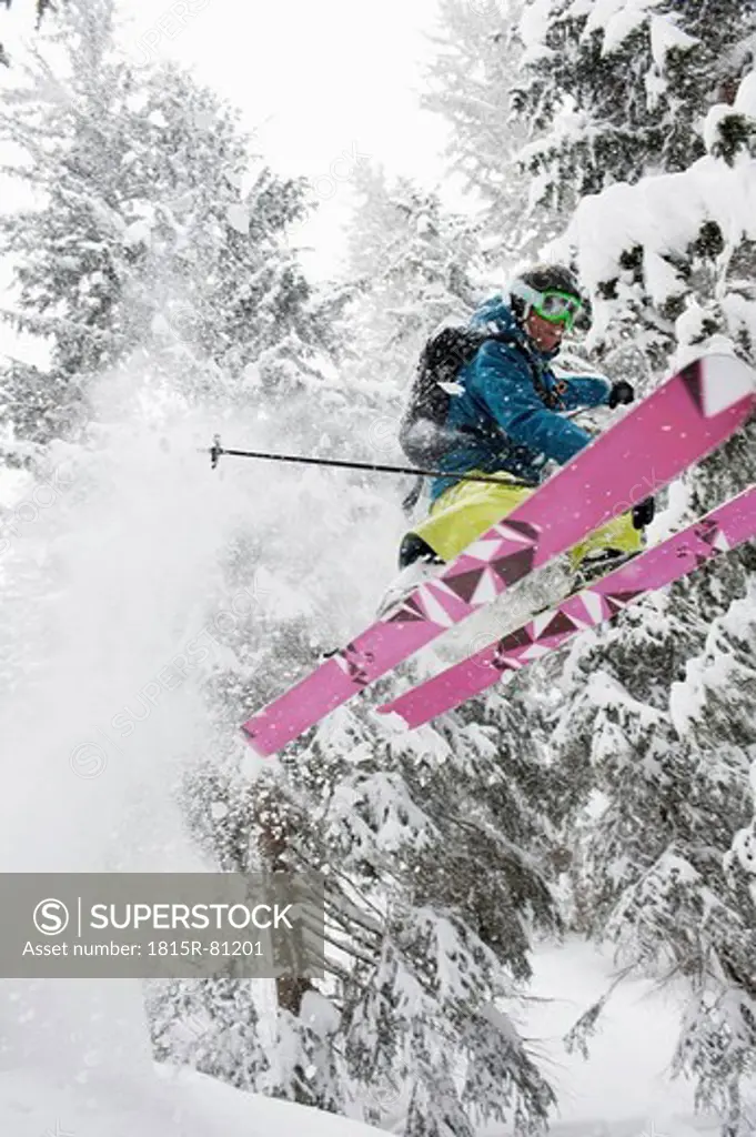 Austria, Kleinwalsertal, Male skier jumping mid_air