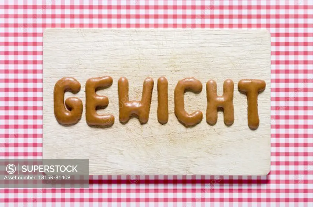 Word weight written with russian bread on dish, close up