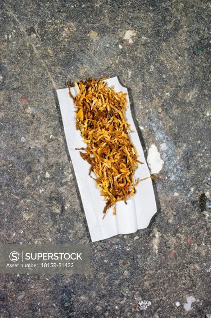 Tobacco in paper in stone floor