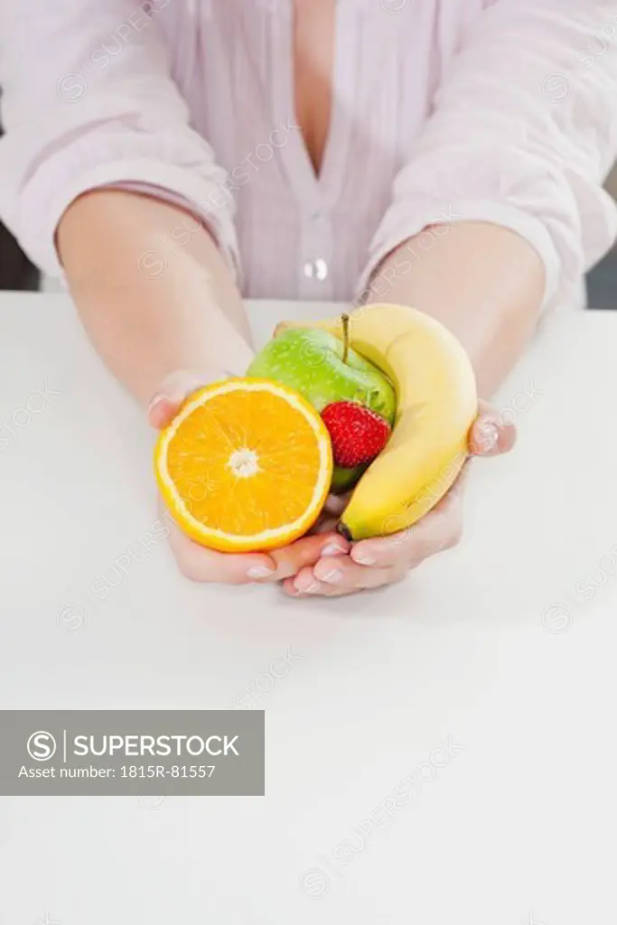 Germany, Cologne, Human hand holding fruits