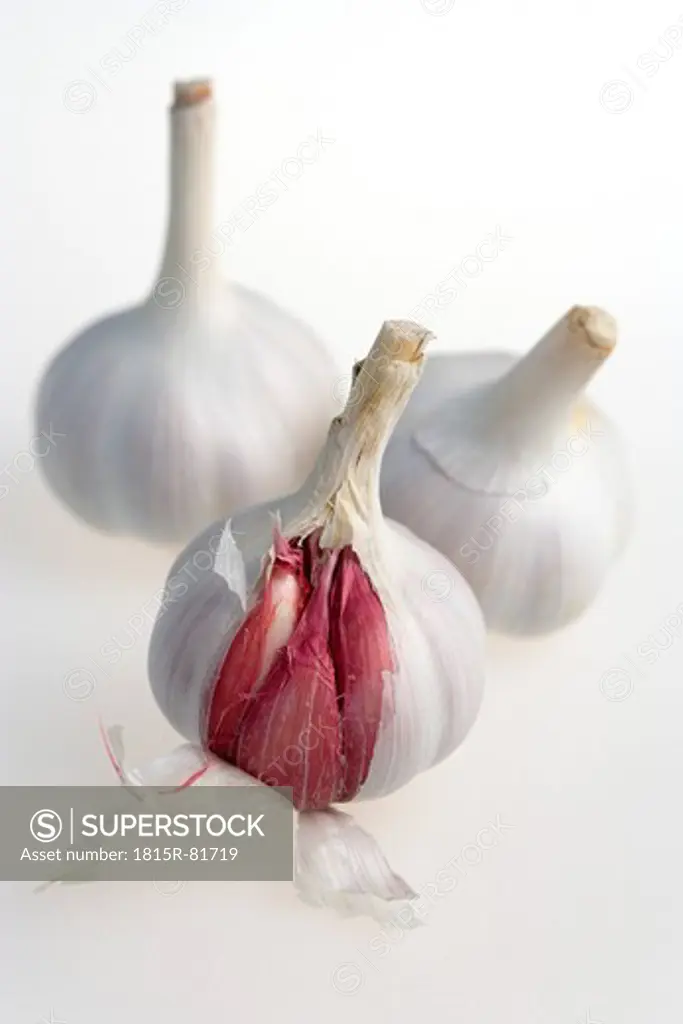 Three garlic bulbs on white background