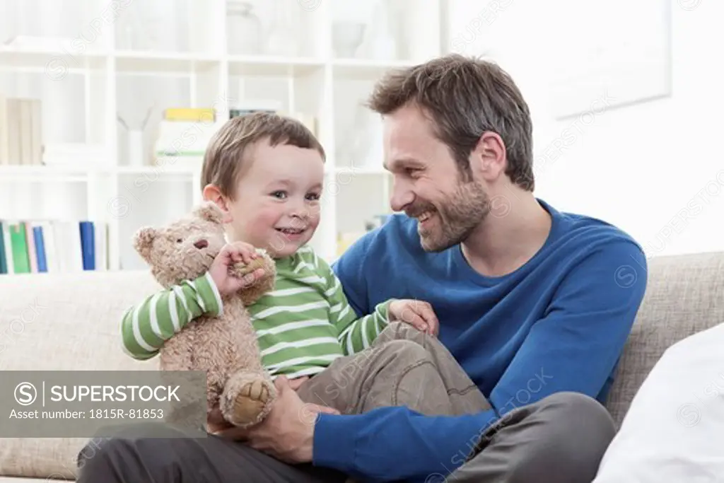 Germany, Bavaria, Munich, Father and son 2_3 Years with teddy bear, smiling