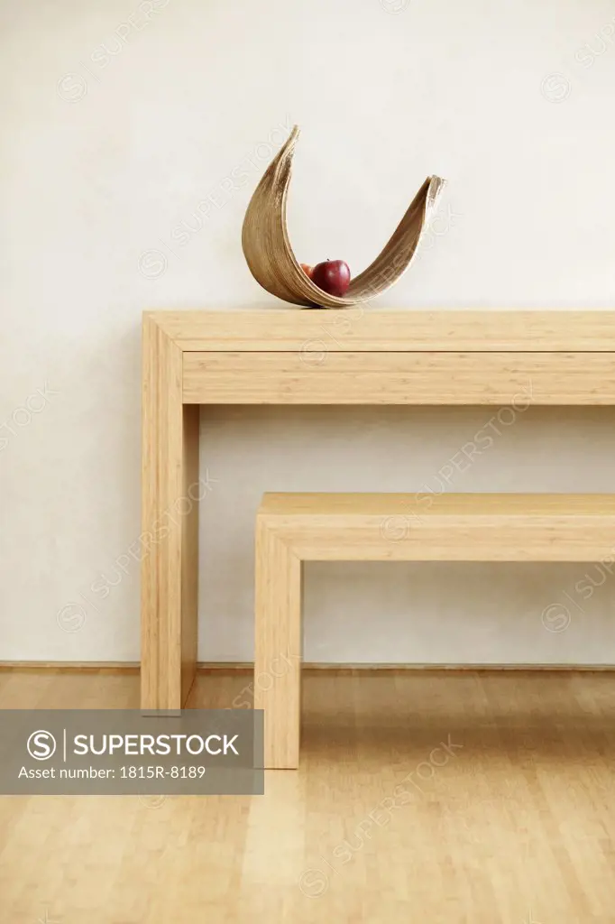 Fruit bowl with apple on table