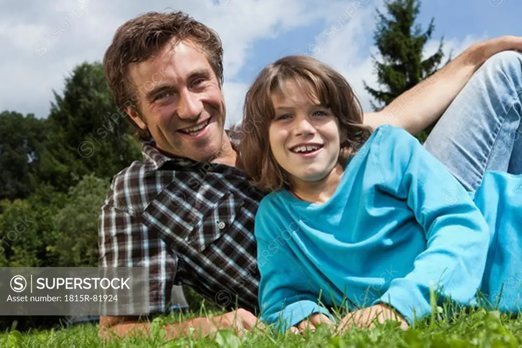 Germany, Munich, Father and son 10_11 Years in garden, smiling, portrait