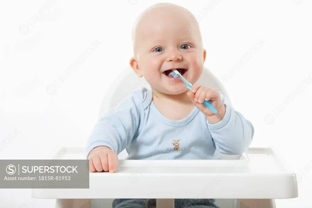 Baby boy 6_ 11 Months brushing teeth, smiling, portrait
